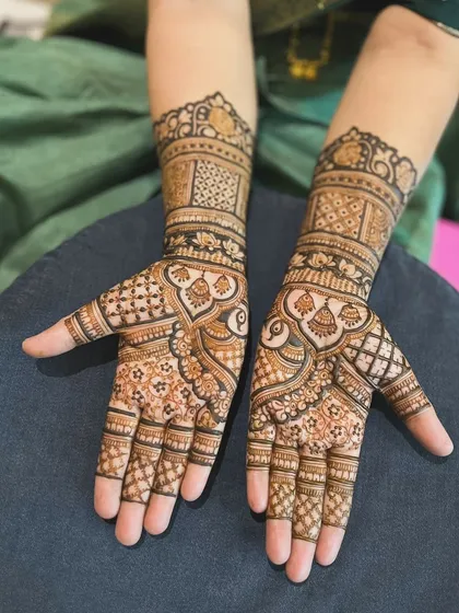 A beautiful and intricate design with a mix of traditional motifs. The patterns are dense and detailed, creating a rich and luxurious feel.