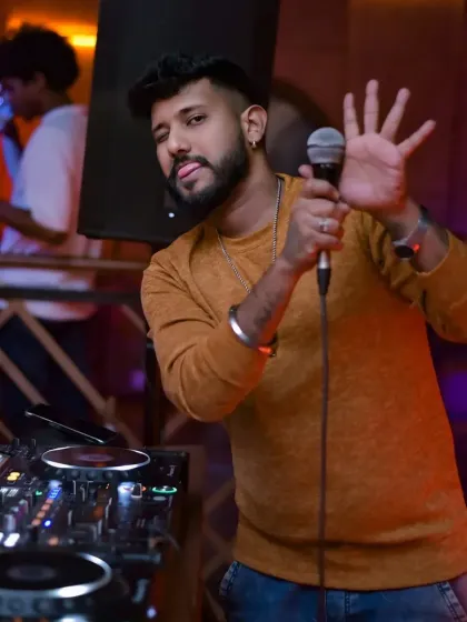 I do more than just play music; I connect with the crowd and keep the energy high all night. Here I am on the mic, making sure everyone is part of the experience.