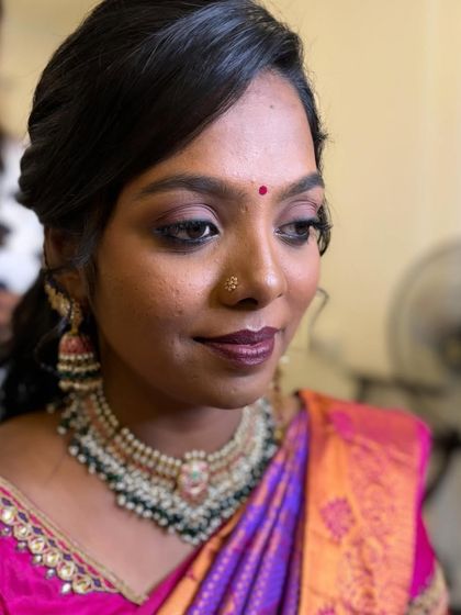 A close-up of the skin-like airbrush base for bride Priyanka's Sirkazhi reception. The smokey eye and deep berry lip add a touch of drama.