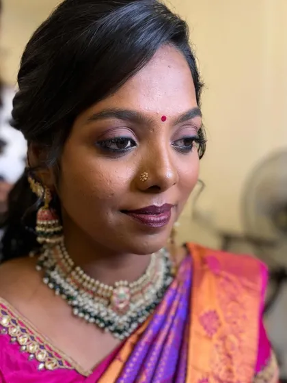 A close-up of the skin-like airbrush base for bride Priyanka's Sirkazhi reception. The smokey eye and deep berry lip add a touch of drama.