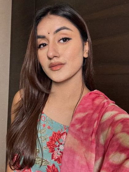 A simple, beautiful selfie in a floral print suit with a pink dupatta and a bindi. Just a quiet moment capturing a traditional aesthetic.