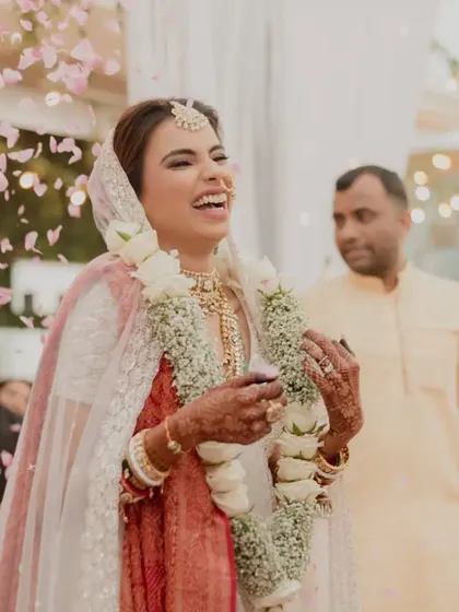 The bride's infectious laughter during the varmala ceremony. Our planning ensures a stress free day filled with happiness and celebration.