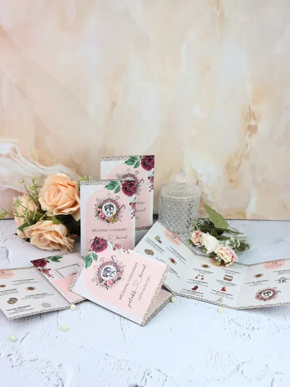 Another look at our custom wedding itineraries, which can be designed to match your wedding theme. This one features a lovely pink and burgundy floral motif.