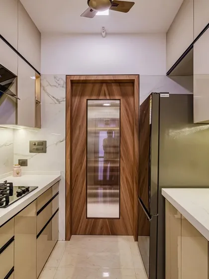 A parallel laminate acrylic kitchen with a wooden door, adding a touch of warmth to the modern design.