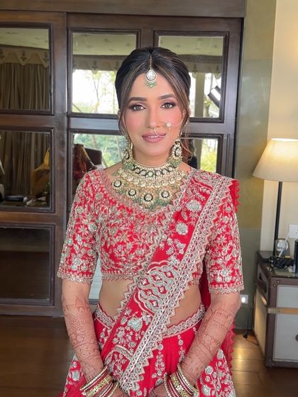 The front view of a classic bridal updo, showing how the soft, face-framing tendrils and center part create a flattering and timeless look for the wedding day.