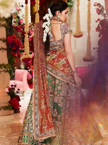 A back view of the custom Anamika Khanna lehenga, showing the beautiful braid and floral arrangement. This is a perfect example of how to style a traditional bridal look.