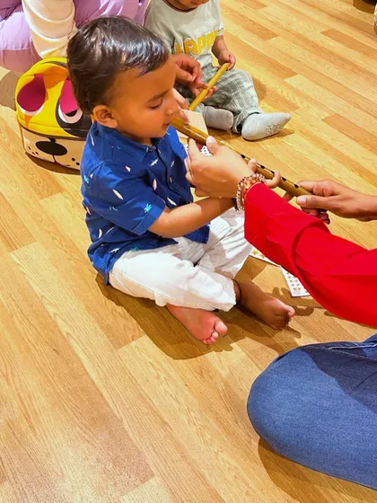 A toddler gets his first introduction to the bansuri (Indian flute). We bring in real artists and instruments to give children an authentic and memorable sensory experience.
