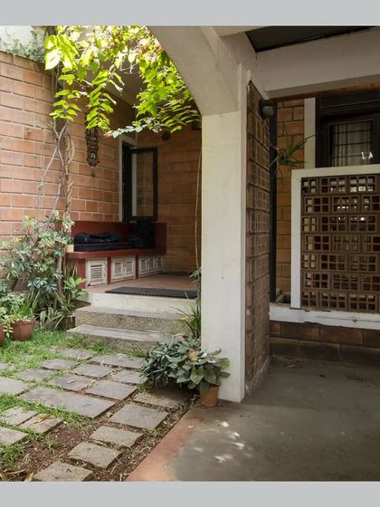 The entrance verandah or 'Jagali', with a built-in bench, providing a traditional semi-open space to transition from outside to inside.