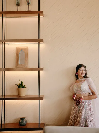 A smiling portrait of the bride against a modern, well-lit interior. Her happiness shines in this beautifully composed shot.