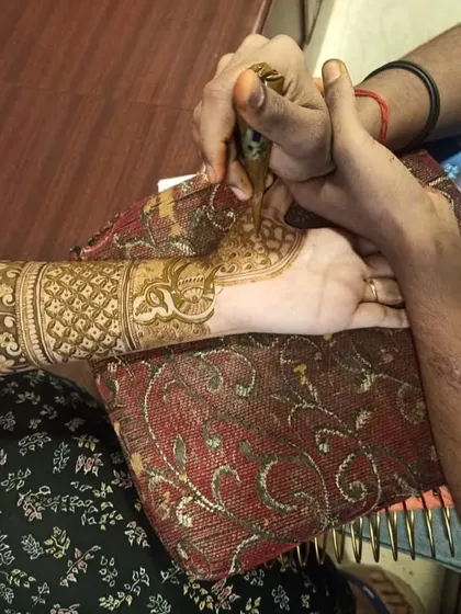 A close-up of my application process. I hold the client's hand steady to ensure clean, sharp lines, which is essential for creating detailed patterns and portraits. Your comfort and the quality of the art are my top priorities.