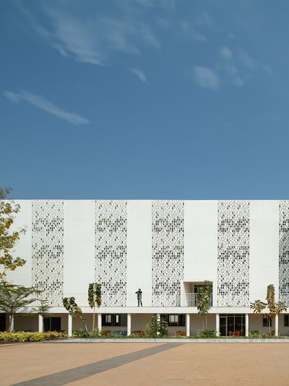 The striking facade of Vidyashilp Academy showcases a balance of simplicity and performance. The vertical bands of perforated screens are not just decorative; they are a key component of our passive cooling strategy, reducing solar heat gain while allowing for privacy and ventilation.