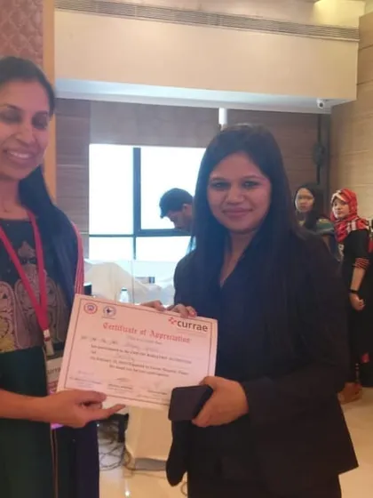 Receiving a certificate of appreciation at a Currae event for my contributions to bariatric nutrition education and patient care.