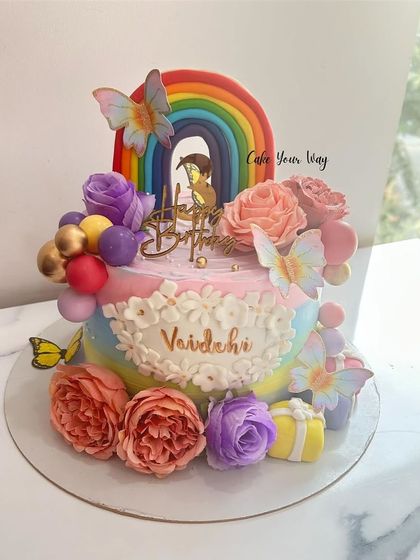 Butterflies, blooms, and rainbows make this cake a dreamy delight.