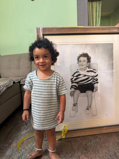 The little boy standing proudly next to his finished, framed portrait. This A1 size piece took over 30 hours of dedicated work.