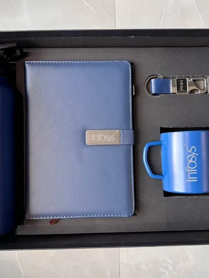 I create fully branded corporate gift sets, like this one for Infosys. This combo includes a 750 ML bottle, an A5 diary, a steel mug, a pen, and a keychain, all in a striking blue and customized with the company logo. This is a great option for employee onboarding kits or client appreciation gifts.