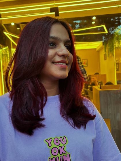 A client looking happy and confident with her new Malbec global hair color. The rich, wine-inspired shade is both bold and beautiful.