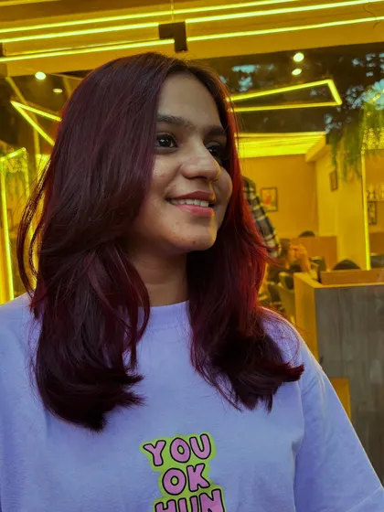 This client's Malbec hair color is styled straight with soft layers, showing off the dramatic yet classy look.