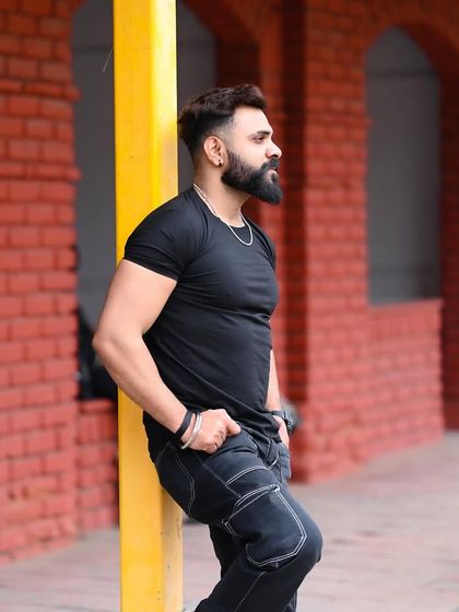 A confident standing pose in an urban setting. This type of shot is great for demonstrating a model's physique and strong presence.