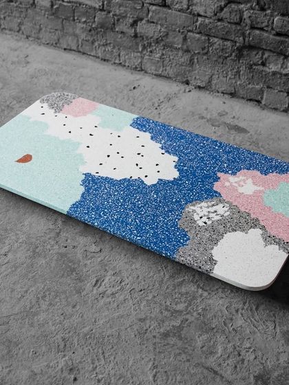 A full view of the custom multicolor terrazzo tabletop, showcasing its playful and artistic character against a simple concrete floor.