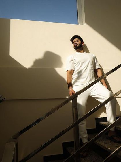 A solo portrait of the groom, using dramatic light and shadow to create a powerful and stylish shot. It's important to capture individual personalities as well as the couple's connection during a pre-wedding shoot.
