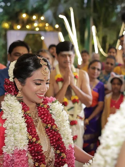 A candid moment from the ceremony. Even in action shots, the makeup looks perfect and enhances her bridal glow.
