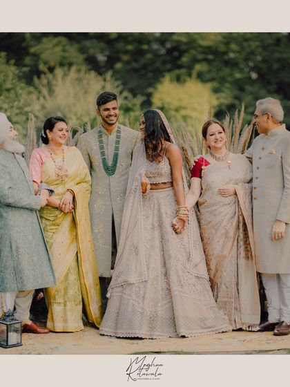 A happy family portrait. We styled the bride, groom, and their parents in elegant, coordinated outfits that reflect a sense of unity and celebration.