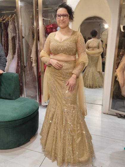This client is rocking a gold sequin fish-cut lehenga. It's a flattering and glamorous style, perfect for a cocktail party or reception.