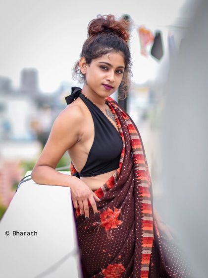 A confident and stylish pose, this rooftop portrait combines traditional attire with a modern, urban attitude.