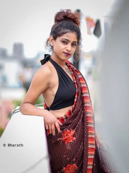Another angle of the fusion saree look, capturing a direct and confident gaze. The messy bun and minimal accessories keep the focus on the modern styling.