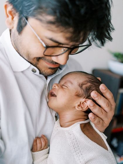 A father's gentle touch. Capturing the bond between a dad and his newborn is always so heartwarming.
