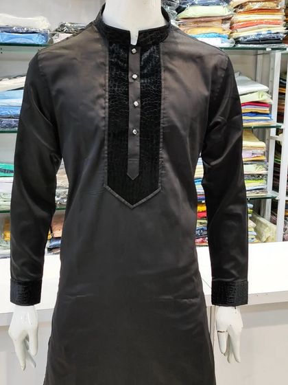 A full view of the jet black Nawab Poshak Kurta on a mannequin, highlighting its unique textured details.