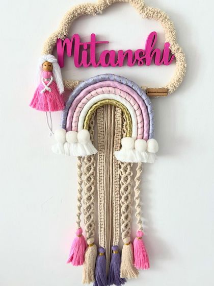 This view of the "Mitanshi" name hanging shows the delicate tassels and the charming little doll that makes this design so special.