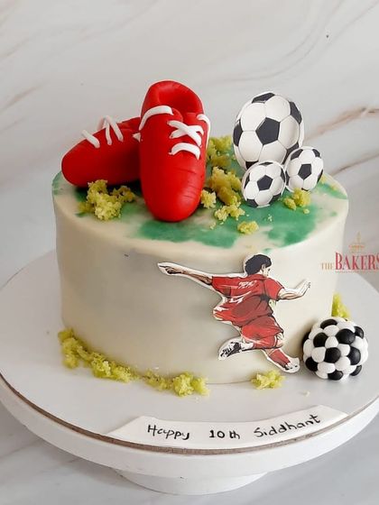 A Ronaldo-themed cake for Siddhant's 15th birthday. This minimal-fondant cake is perfect for a football enthusiast, featuring edible soccer balls, cleats, and an action shot of the player.