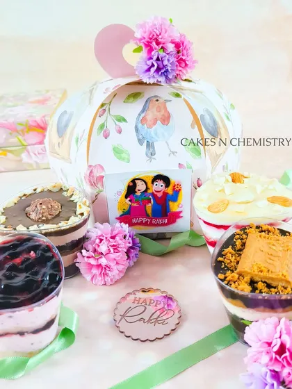 A beautiful Rakhi gift hamper featuring an assortment of my dessert jars. These single-serving treats come in a variety of flavours like Blueberry, Lotus Biscoff, and Ferrero Rocher, all packed in a lovely gift box.