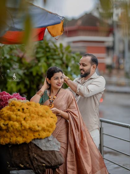 A sweet gesture of him fixing her hair at the flower stall. These small, tender moments are beautiful to capture.