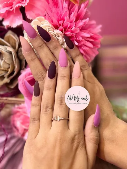 Are you a purple fan? This stunning set features long, matte stiletto nails in various shades of pink and purple for a chic, multi-tonal look.
