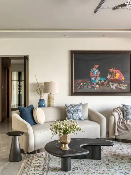 In this home, minimalism finds meaning. The living room is a cultural expression rooted in restraint, fluidity, and warmth. Curvilinear forms soften the geometry, while traditional Indian art anchors the space in memory and heritage.