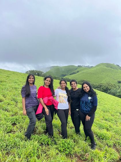 A group of friends posing on the green meadows of Bandaje.