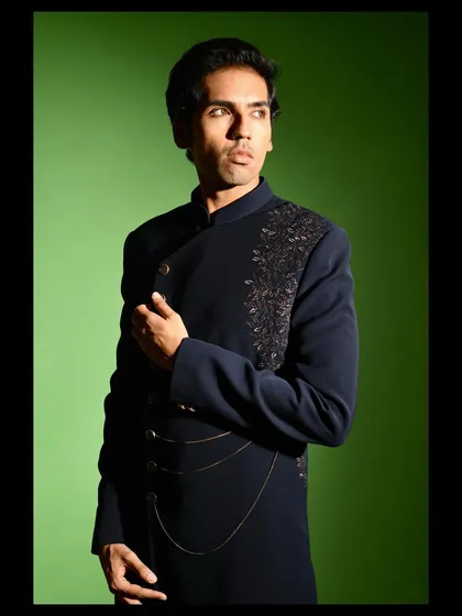 The angrakha style cut of this Indo western jacket is a modern interpretation of a classic silhouette. It is tailored to create a flattering, slim profile while allowing for comfortable movement.