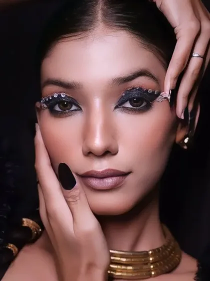 A stunning Arabic-inspired beauty portrait, with dramatic winged eyeliner, rhinestone details, and a bold gold choker, creating a look of modern royalty.