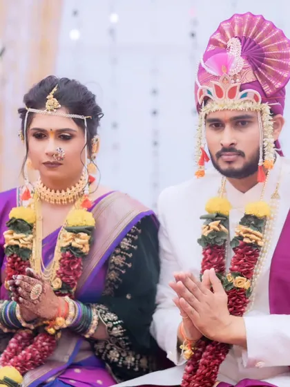 A traditional wedding ritual scene. The bride's makeup remains flawless, highlighting her features beautifully under the event lighting.