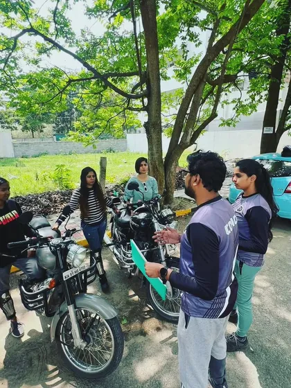An outdoor classroom session. We gather around the bikes to discuss theory and technique before putting it all into practice.