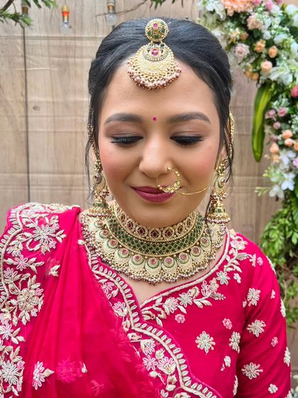 A close-up of the bride's face, showcasing the detailed eye makeup and the perfect pairing of her jewelry with the soft, elegant makeup tones.