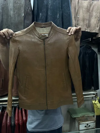 This is a women's leather jacket in a beautiful tan brown colour. The cut is tailored for a flattering fit, making it a versatile addition to any wardrobe.