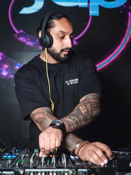 In the zone, crafting the perfect set. Every track is chosen to build momentum and create a unique musical journey, whether it's commercial hits, deep house, or Bollywood bangers.
