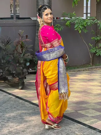 A side profile of the Brahmani Navari drape, showing the unique way the pleats are tucked at the back. This style is known for its comfort and elegance, making it a popular choice for wedding ceremonies.