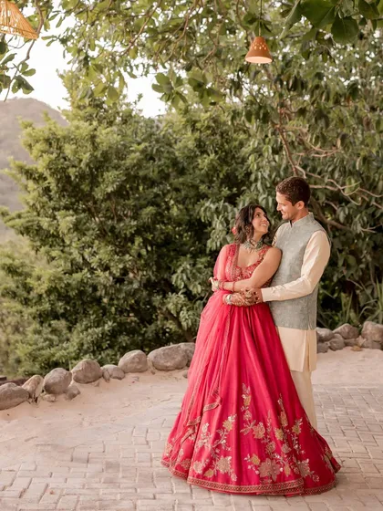 A fun and vibrant Sangeet look. Aditi is radiant in a fuchsia Ridhi Mehra lehenga, light enough to dance in, while Diego keeps it classic and comfortable in a custom-made kurta and bandi set.