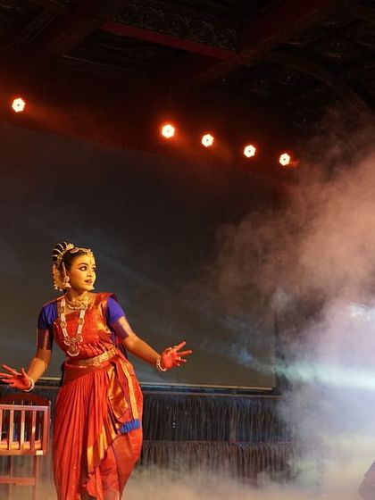 A scene depicting the birth of Krishna, with dancers gathered around his cradle. The use of smoke and dramatic lighting adds a layer of mystique and reverence to the moment.