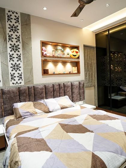 In this master bedroom, I combined a comfortable upholstered headboard with decorative wall panels and a lit display niche for personal items, creating a space that is both stylish and personal.