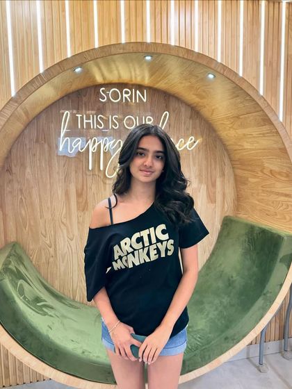 A young client looking cool and confident after her hair styling session.